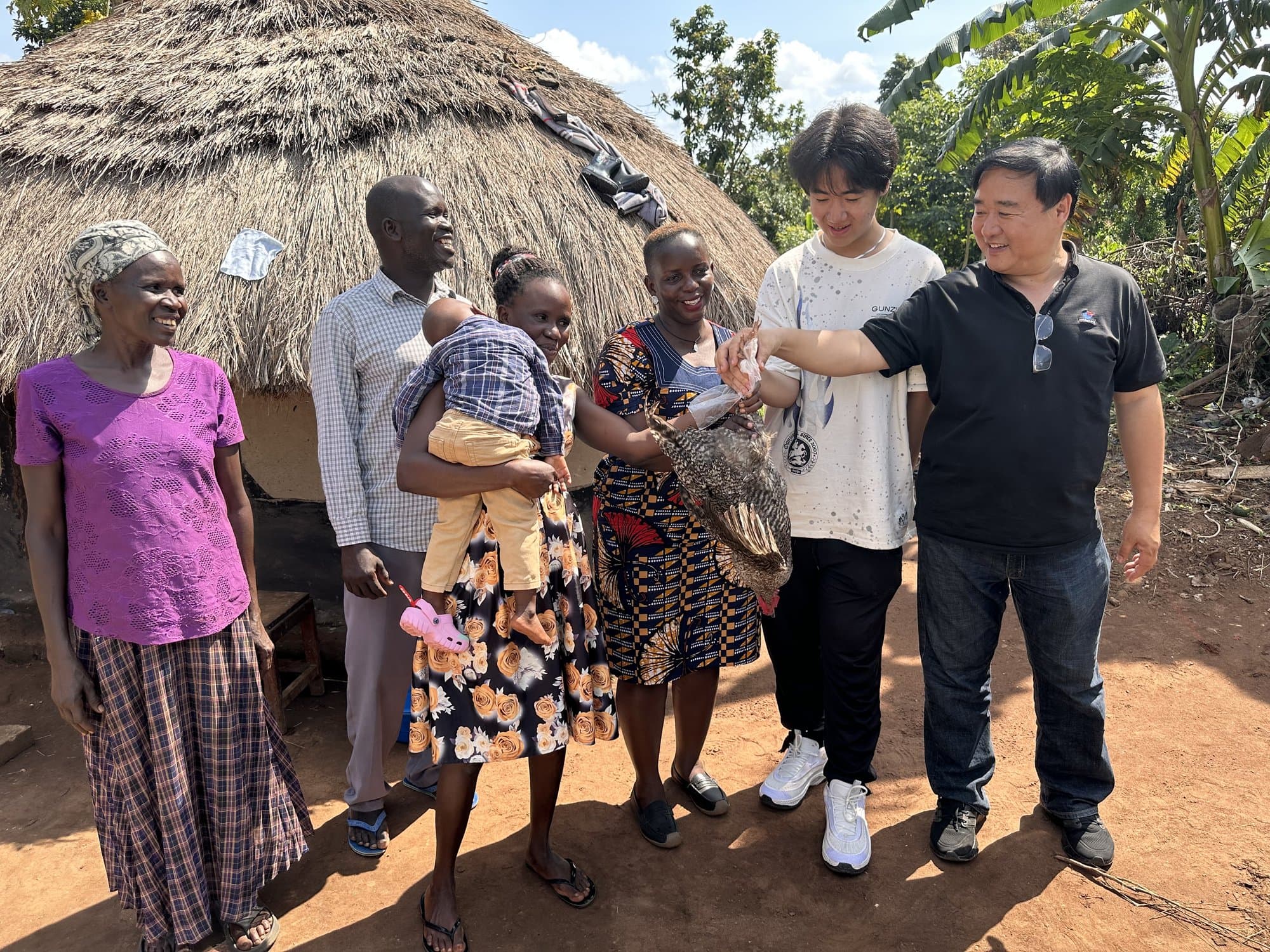 Eric Wang and a community group gathered together in Uganda